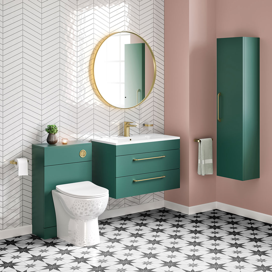 Forest green vanity unit with brushed brass taps and handles on pink wall